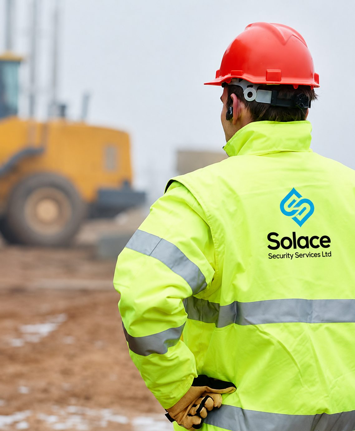 Solace security officer in a hard hat watching over a construction site