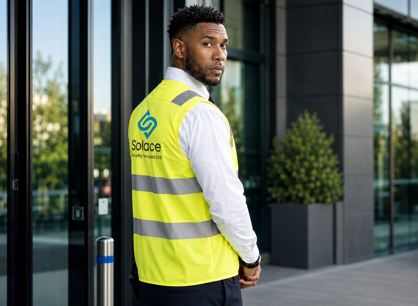 Solace door supervisor standing at the entrance of a commercial building